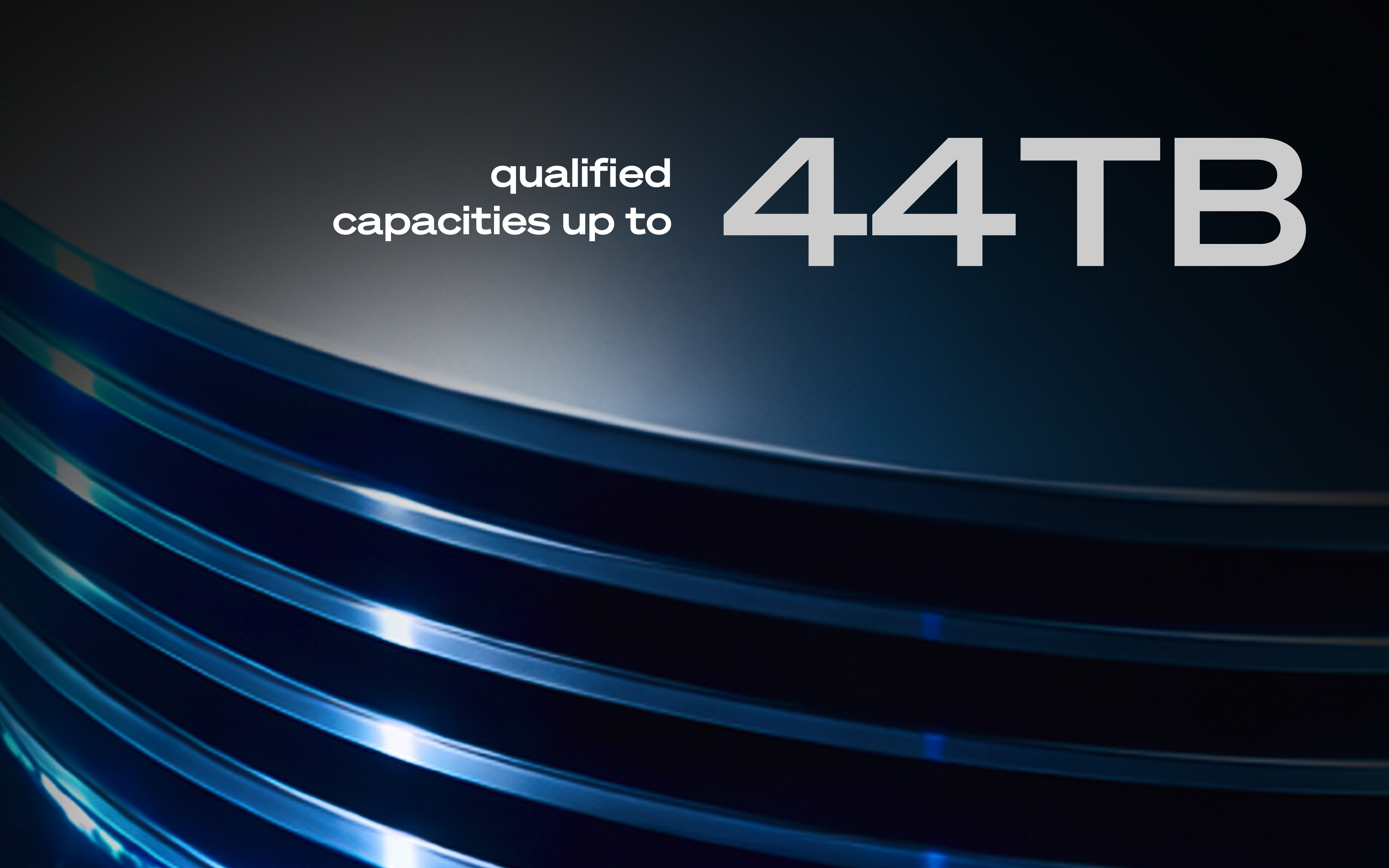 Text reading ‘qualified capacities up to 44TB’ over a dark background featuring the illuminated curved platters of a hard drive.