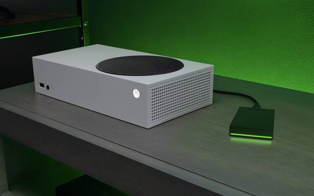 Black Seagate external hard drive plugged into a white Xbox gaming system.