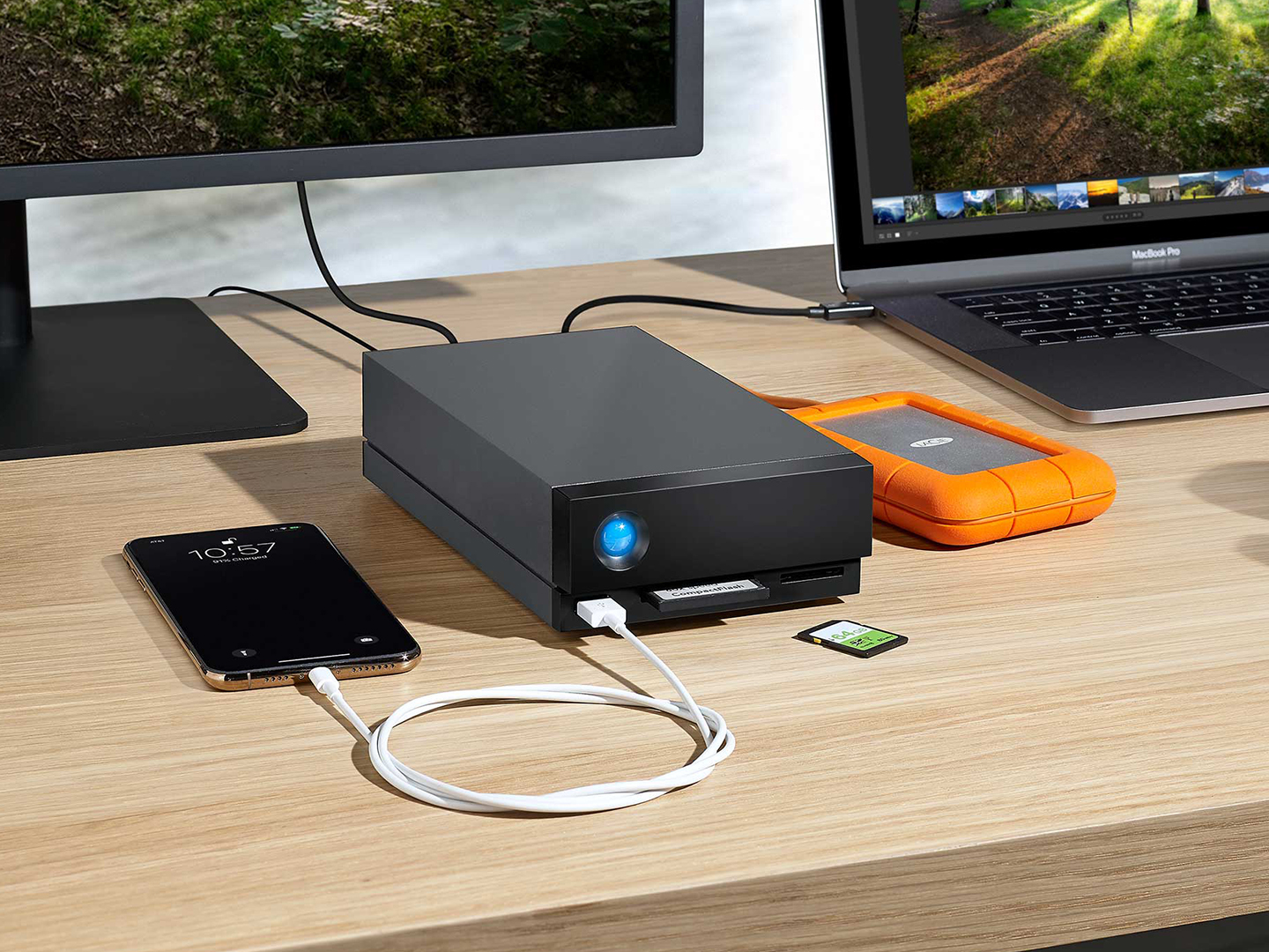 Laptop, desktop and phone are connected to LaCie 1big Dock and Rugged Mini drive.
