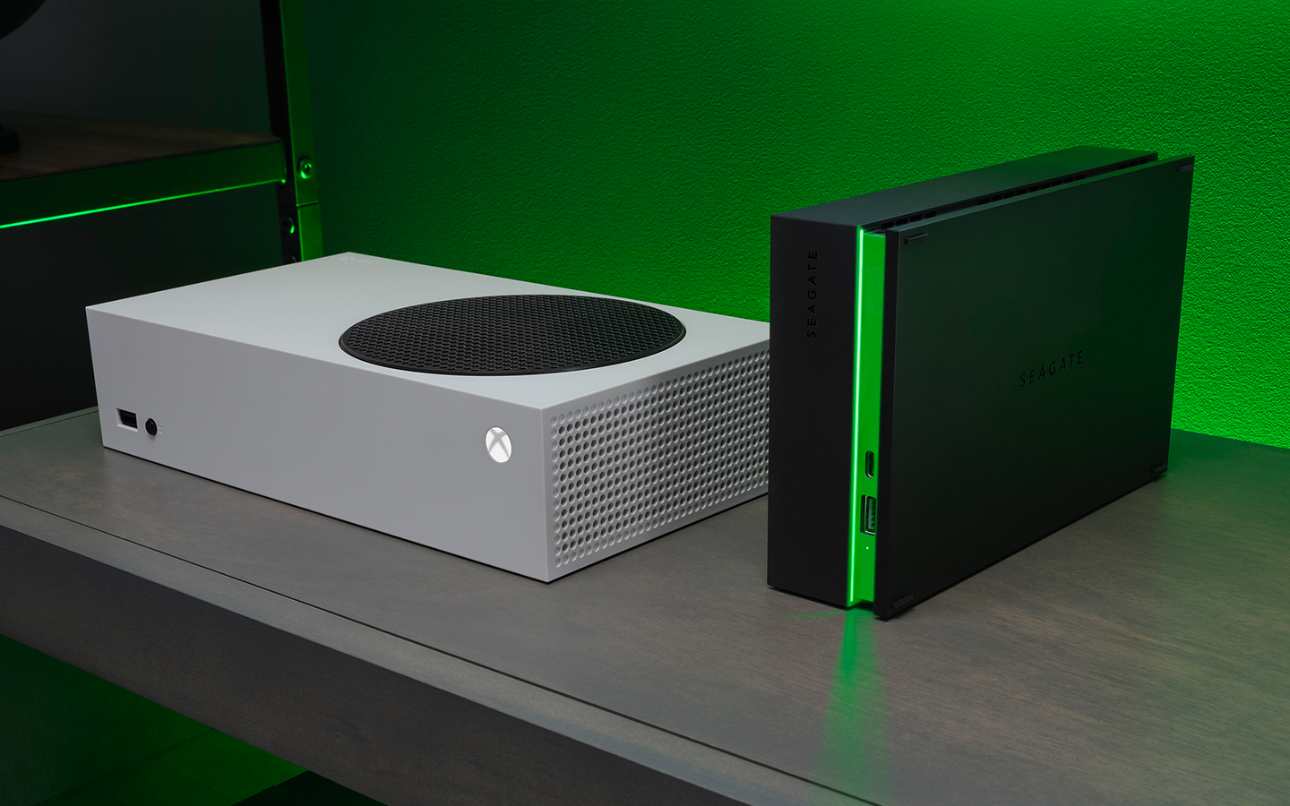 White Xbox Series S console is positioned next to a black Seagate Game Drive Hub for Xbox with green accent lighting.