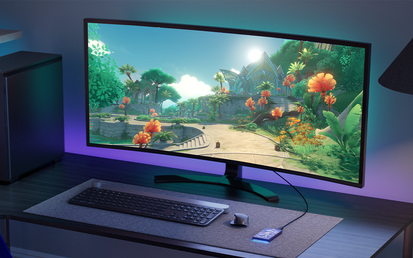 Wide-screen desktop display featuring gaming graphics is connected to a Seagate portable hard drive.