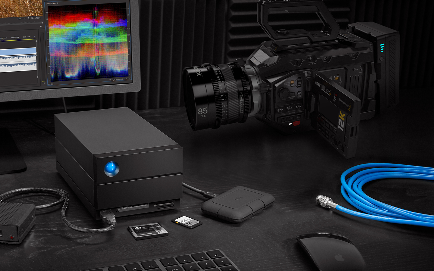 Edit studio features LaCie 2big Dock hard drive, mini drive, desktop, SSD cards, keyboard, and video camera.