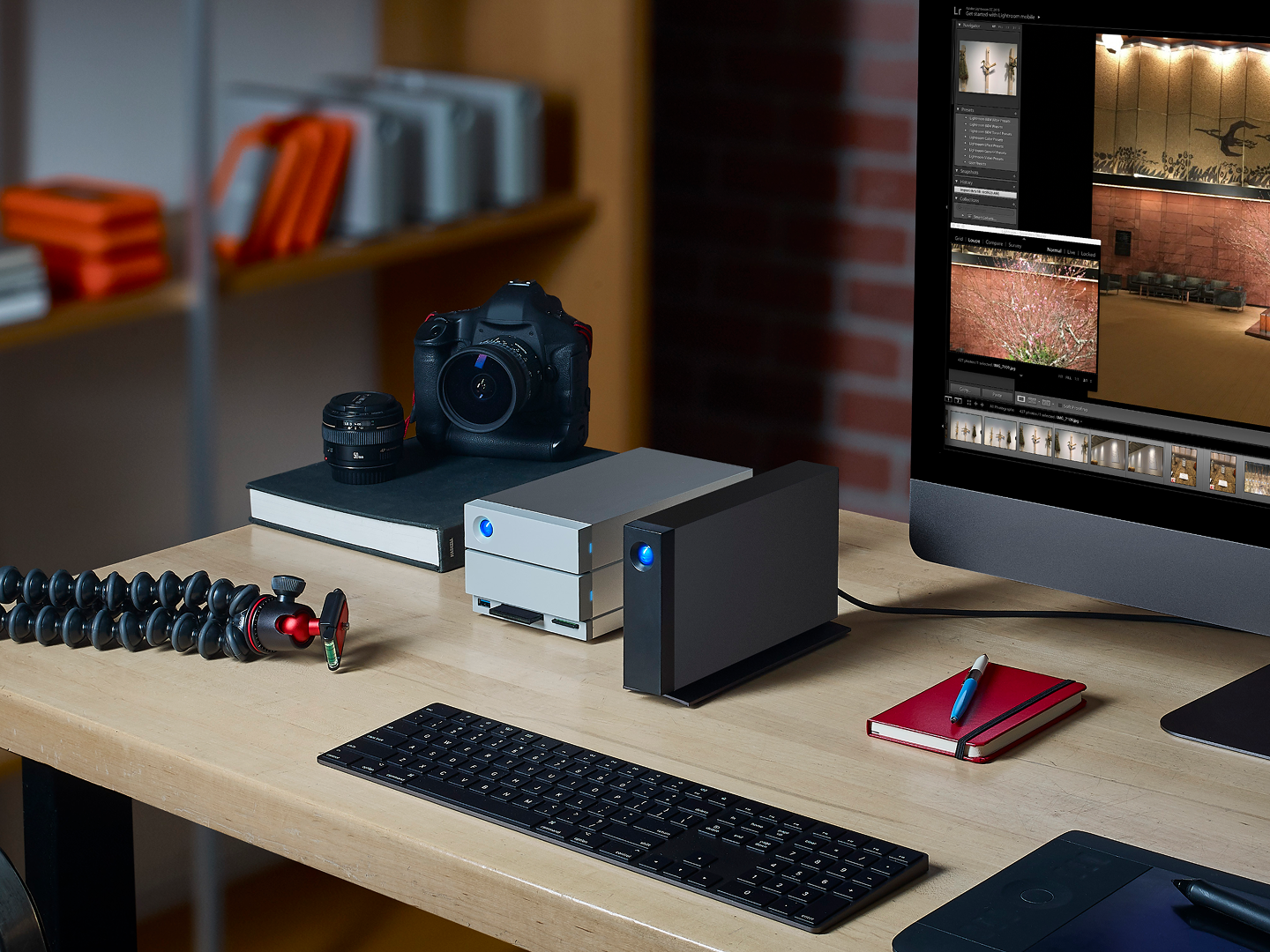 Photo editing setup features LaCie 2big RAID, d2 Professional, desktop screen, camera, notebook, and keyboard.