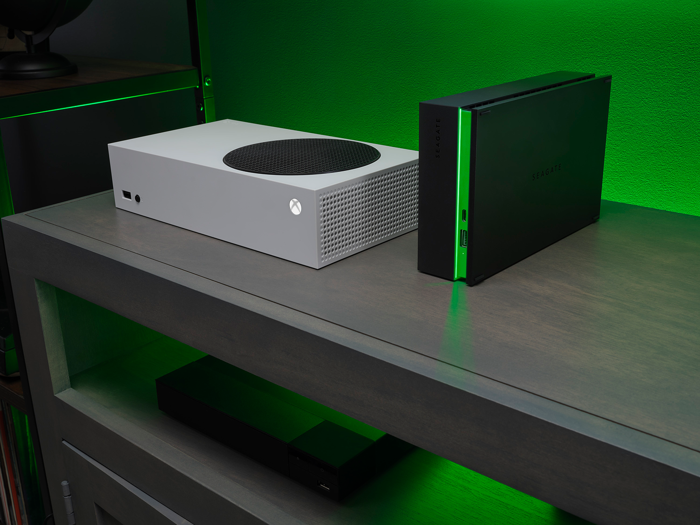White Xbox Series S console is positioned next to a black Seagate Game Drive Hub for Xbox with green accent lighting.