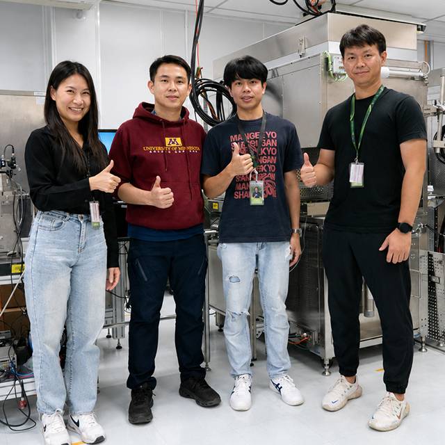 Four Seagate employees standing together in an engineering lab.